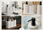 White bathroom accessories set with black pumps on a marble countertop.