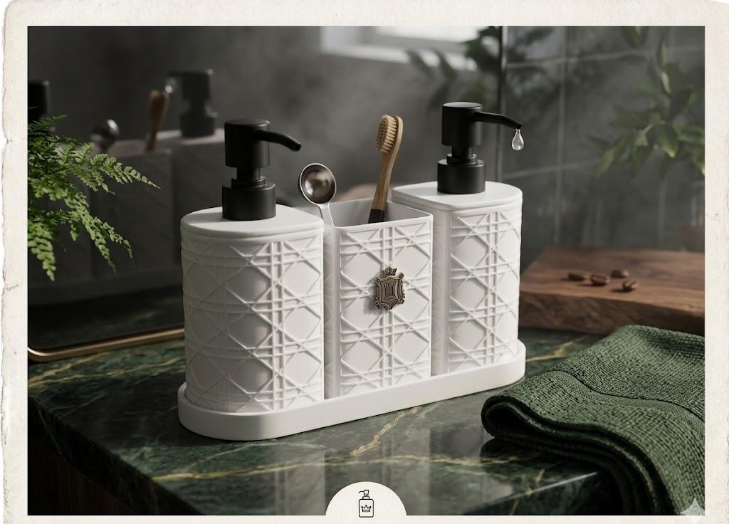 A white bathroom vanity organizer set with two black pump bottles, a toothbrush holder, and a small metal spoon holder, styled on a green marble countertop with a folded green towel and mirror reflections in the background.